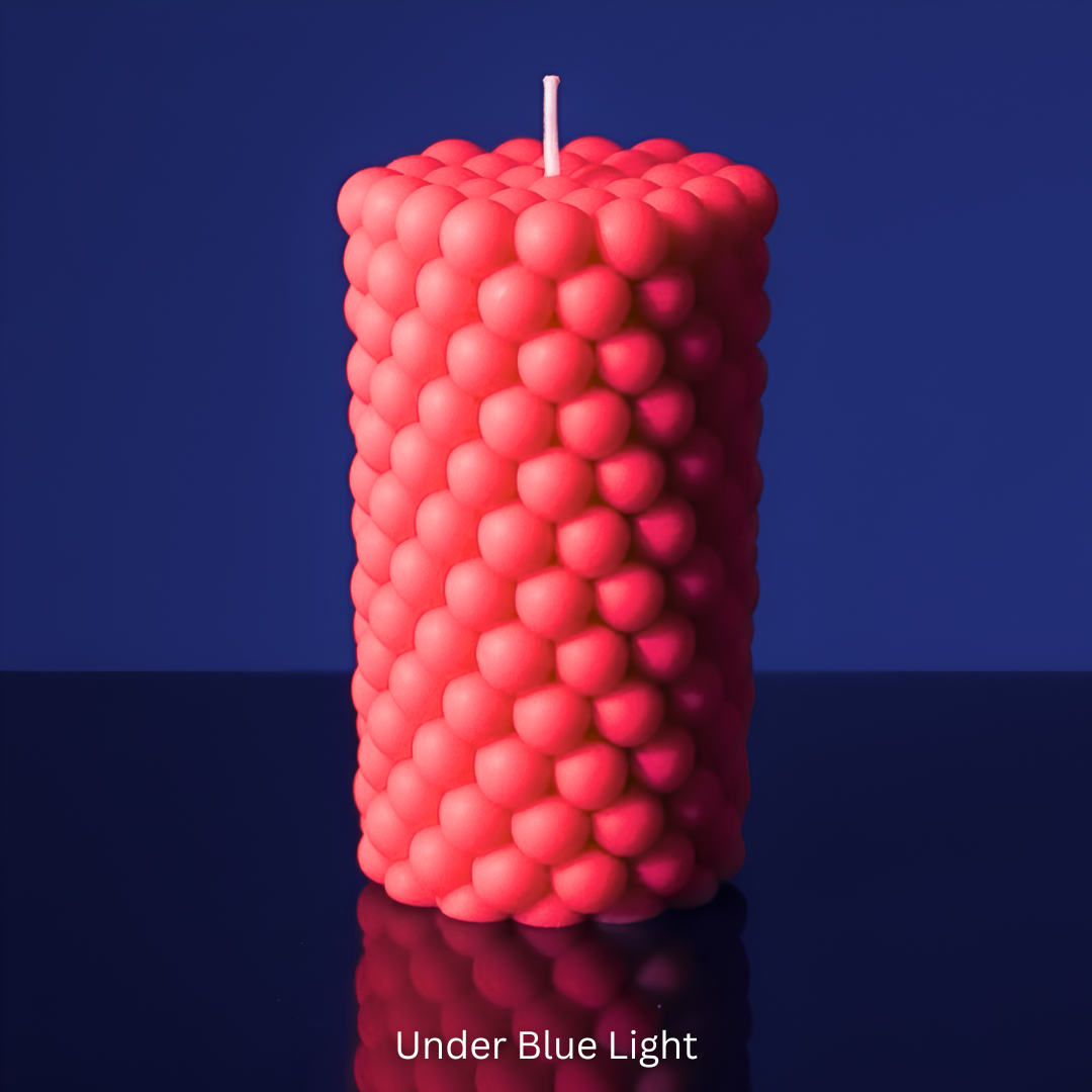 bubble-textured pillar candle on a reflective surface with a blue background under UV Light
Sensations Unleashed BDSM UV Wax Play Bubble Pillar Candle In India